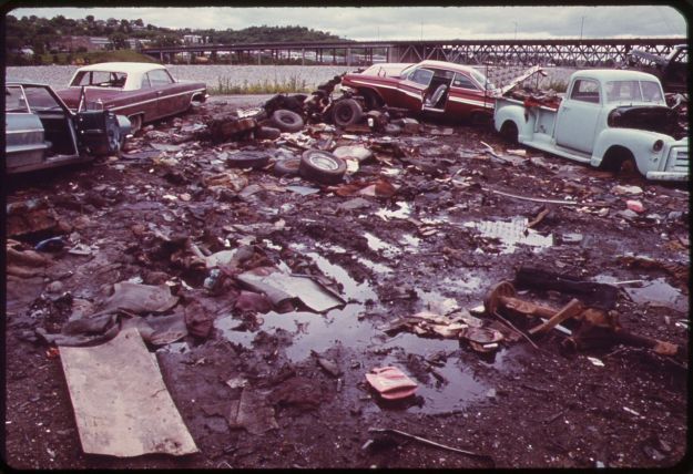Automobile Junkyard on the North Bank of the Kansas River between the 12th and 18th street bridges. Kenneth Paik, 1973. Wikimedia Commons.